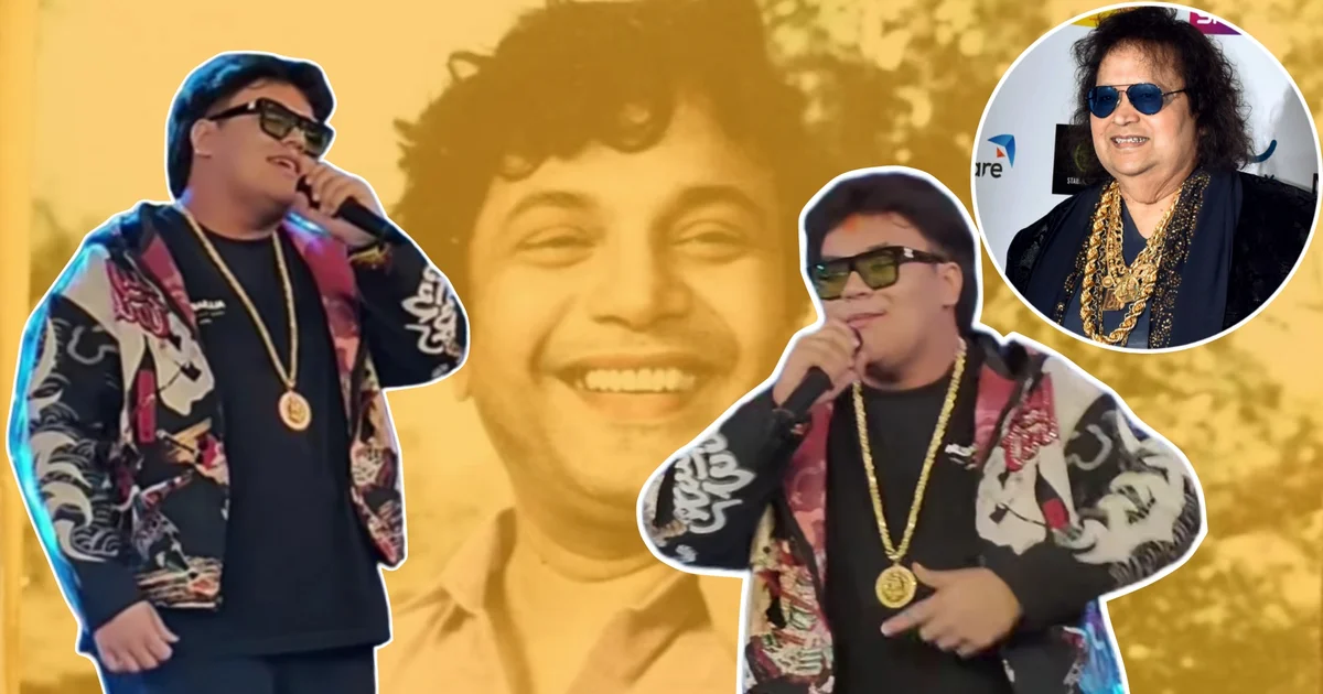 Rego B, Bappi Lahiri Grandson, Uttam Kumar Birth Centenary, Uttam Kumar 100, Nandan Kolkata, Rego B Song, Rego B Controversy, Bappi Lahiri, Uttam Kumar Centenary Celebration, Bengali Music, Bengali Entertainment, Social Media Controversy, রেগো বি, বাপ্পি লাহিড়ীর নাতি, উত্তম কুমারের জন্মশতবর্ষ, উত্তম কুমার ১০০, নন্দন কলকাতা, রেগো বি গান, রেগো বি বিতর্ক, বাপ্পি লাহিড়ী, উত্তম কুমারের শতবর্ষ উদযাপন, বাংলা গান, বাংলা বিনোদন, সোশ্যাল মিডিয়া বিতর্ক